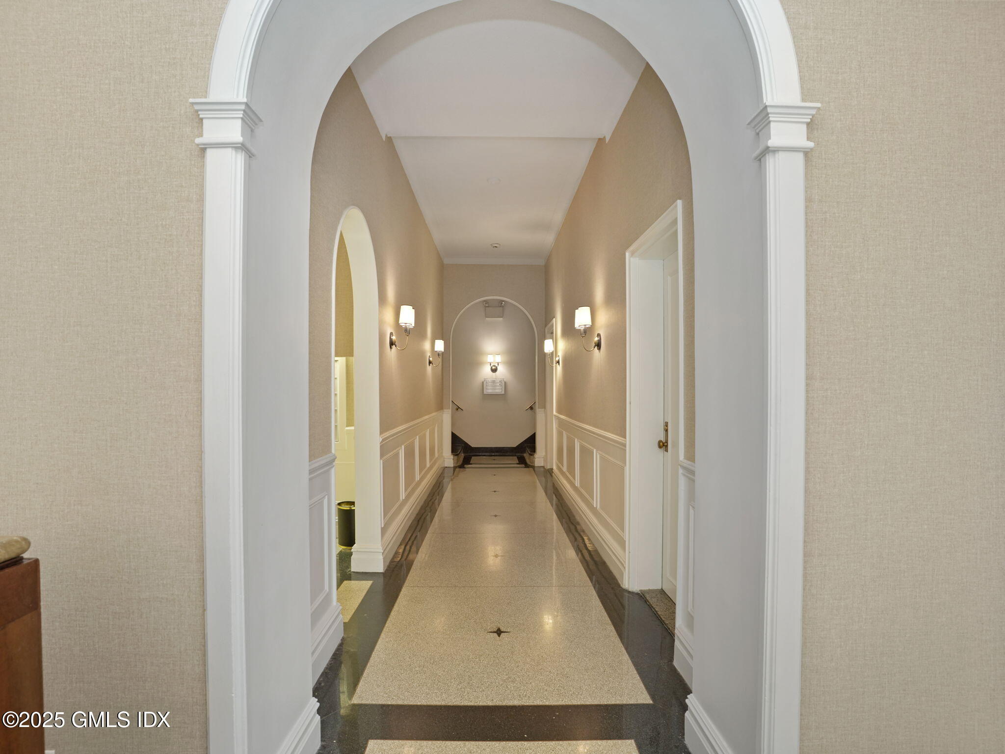 40 West Elm Street, Unit 1M Greenwich, CT 06830 - Photo 2 of 16 a view of a hallway with wooden floor and a livingroom