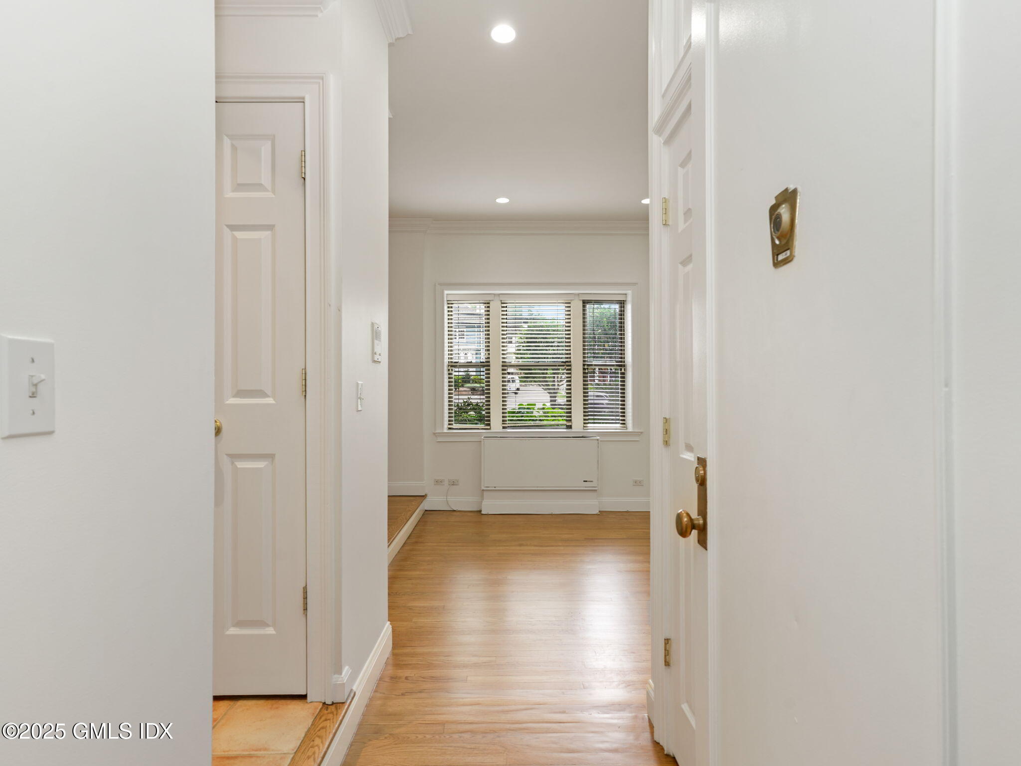 40 West Elm Street, Unit 1M Greenwich, CT 06830 - Photo 3 of 16 a view of a hallway with wooden floor and a window