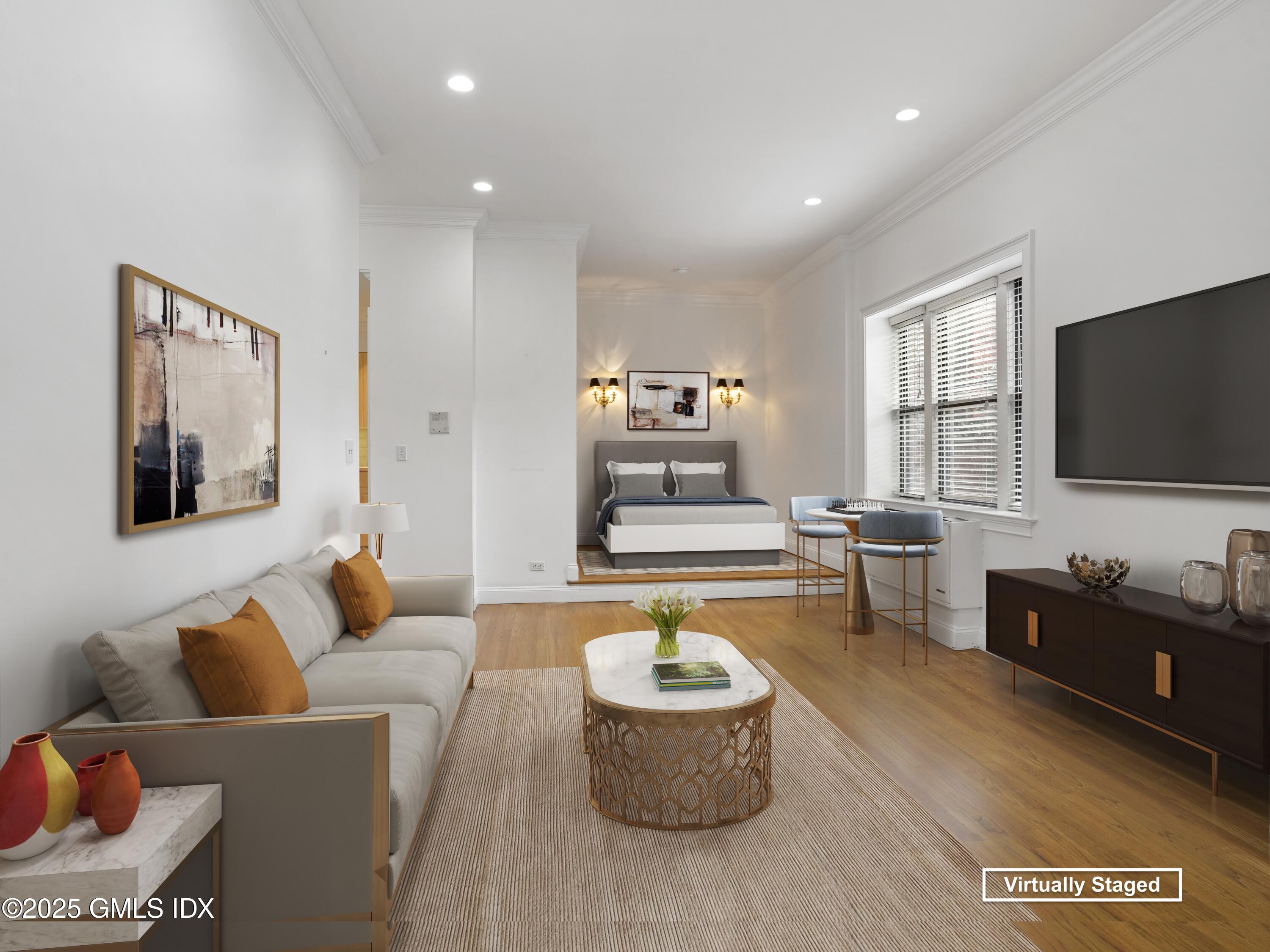 40 West Elm Street, Unit 1M Greenwich, CT 06830 - Photo 6 of 16 a living room with furniture and a flat screen tv