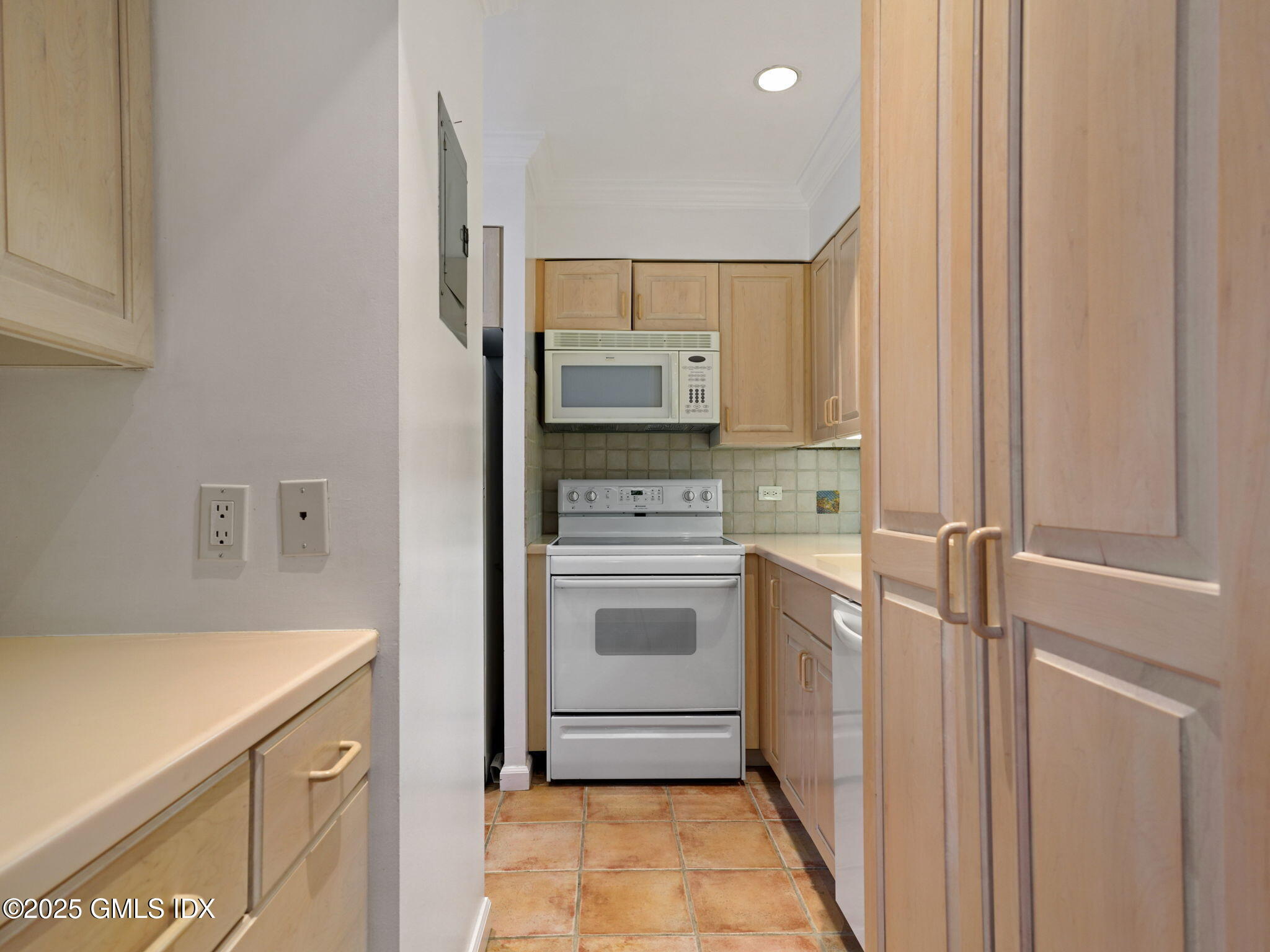 40 West Elm Street, Unit 1M Greenwich, CT 06830 - Photo 10 of 16 a kitchen with a stove top oven and cabinets