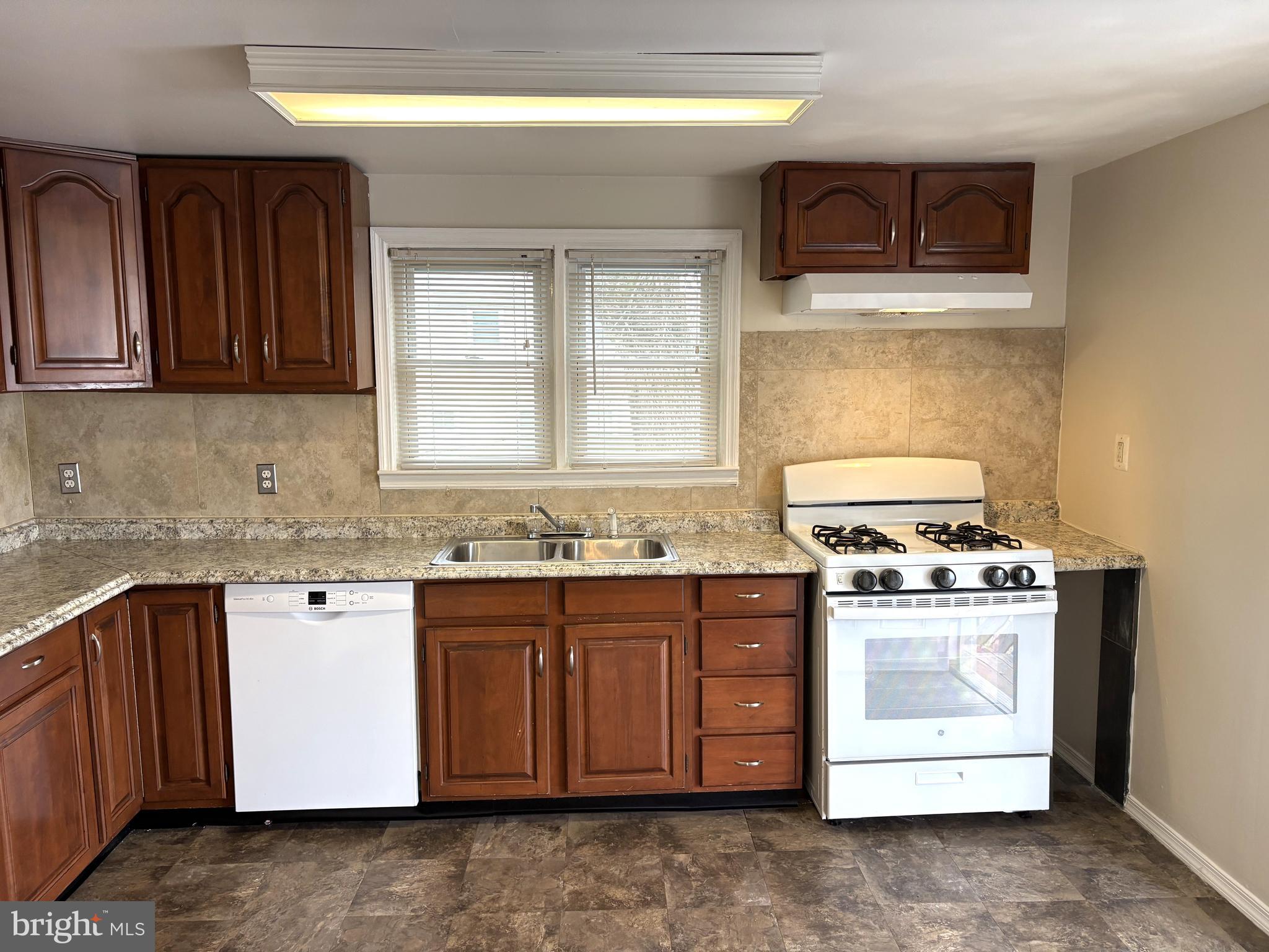 7717 Baltimore Annapolis Boulevard, Unit B Glen Burnie, MD 21060 - Photo 11 of 17 a kitchen with stainless steel appliances granite countertop a stove sink and cabinets