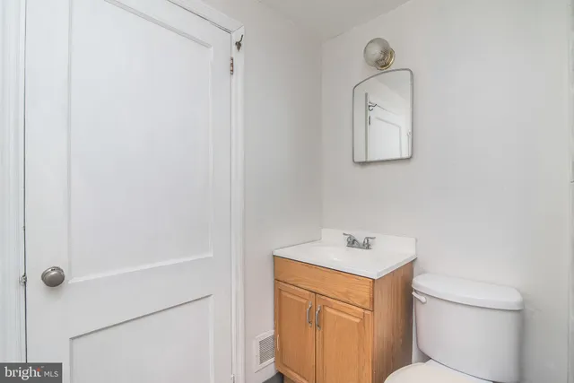 a bathroom with a sink a toilet and a mirror