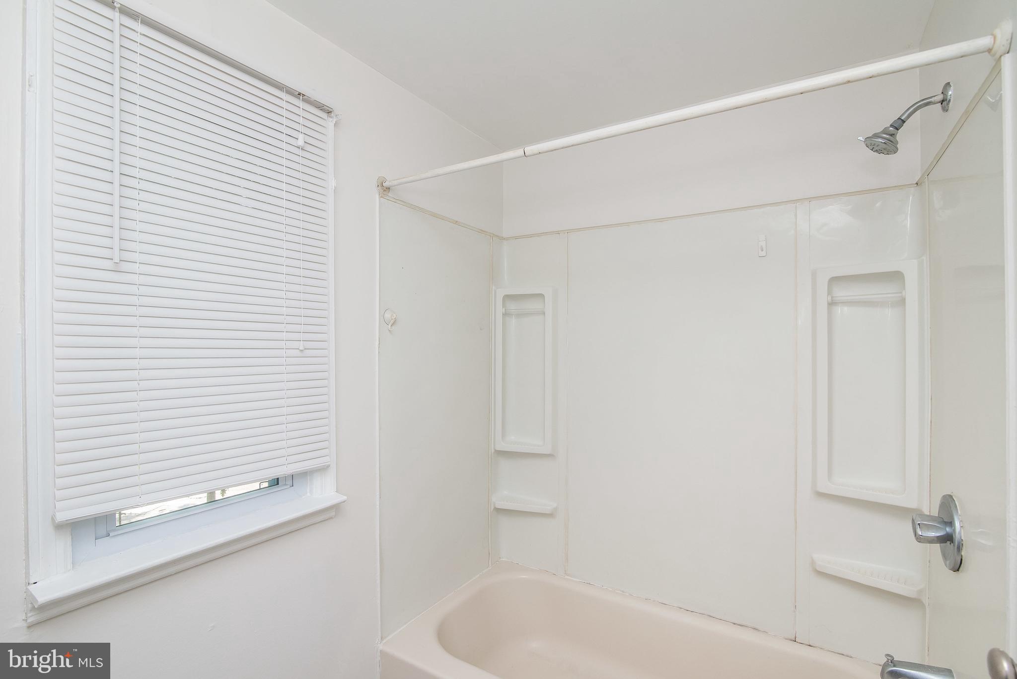 7717 Baltimore Annapolis Boulevard, Unit B Glen Burnie, MD 21060 - Photo 16 of 17 a bathroom with a bathtub and a shower