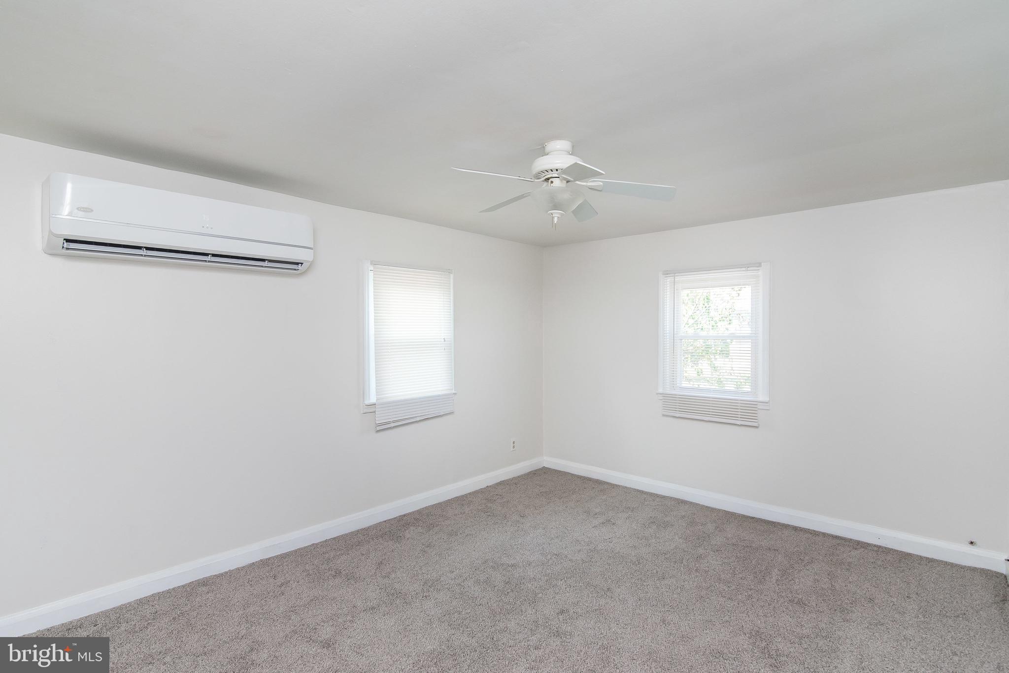 7717 Baltimore Annapolis Boulevard, Unit B Glen Burnie, MD 21060 - Photo 5 of 17 an empty room with a window and a ceiling fan