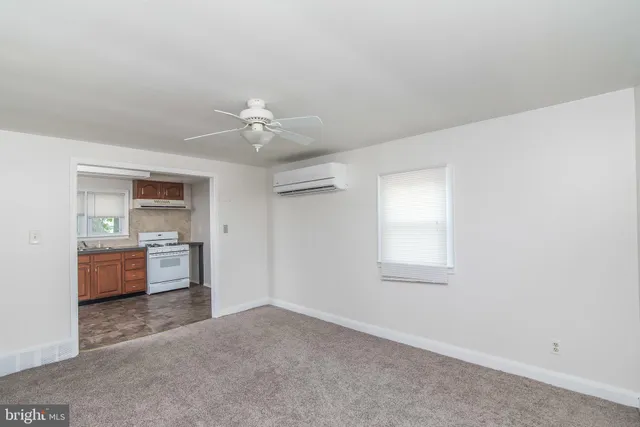 a view of a kitchen with a sink dishwasher a stove and a microwave oven