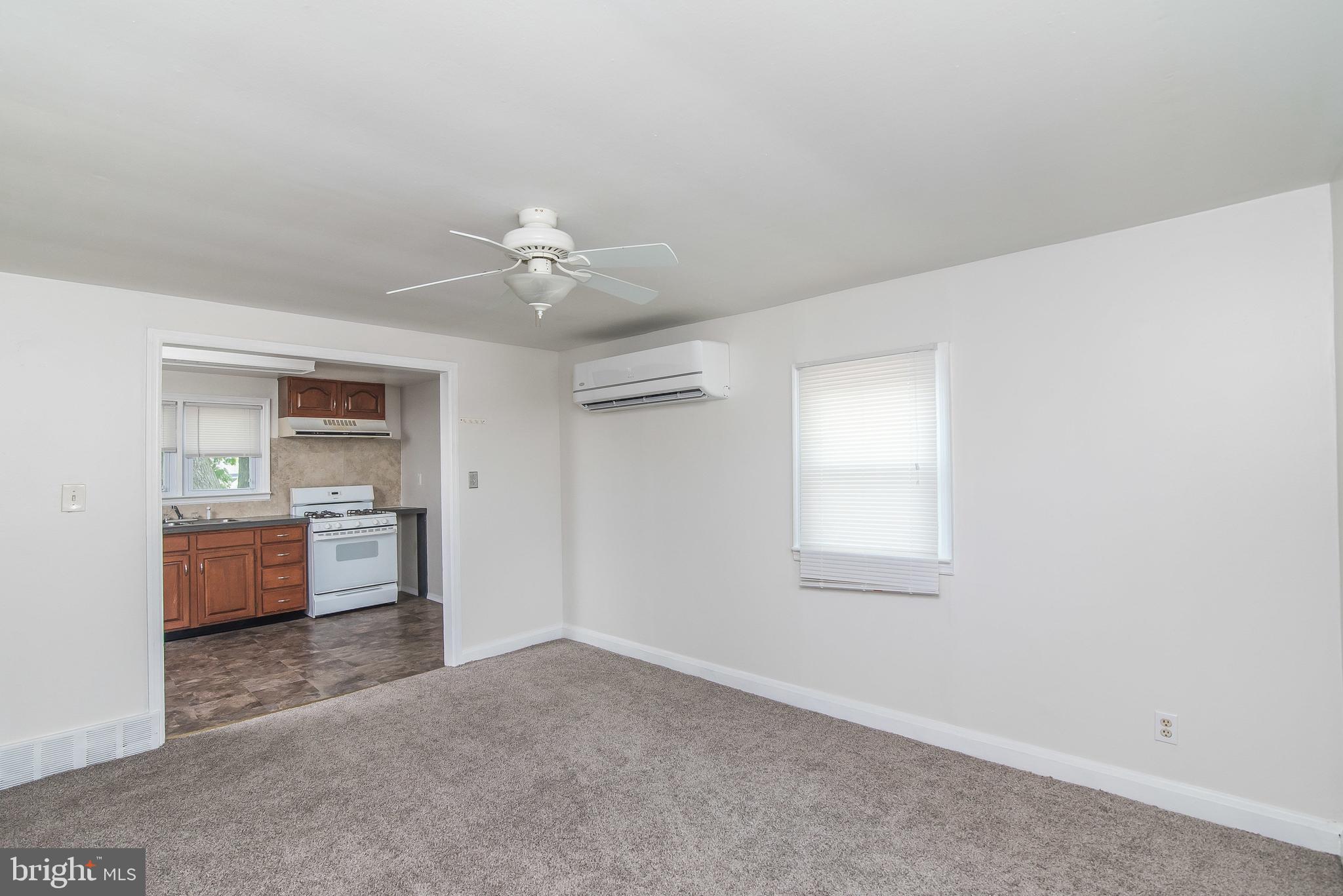 7717 Baltimore Annapolis Boulevard, Unit B Glen Burnie, MD 21060 - Photo 6 of 17 a view of a kitchen with a sink dishwasher a stove and a microwave oven