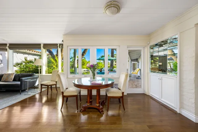 a view of a dining room with furniture window and wooden floor