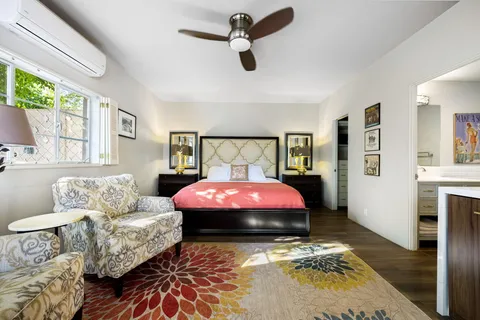 a living room with furniture and a floor to ceiling window