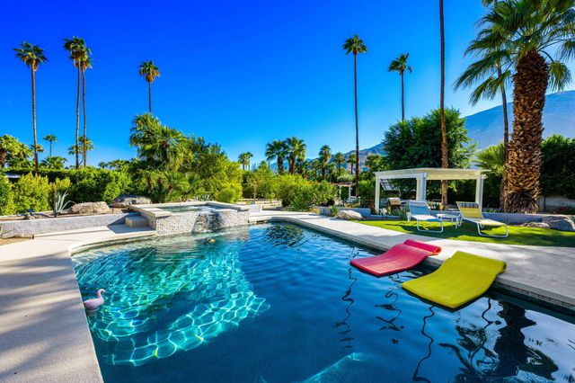 a view of a swimming pool with a lounge chairs