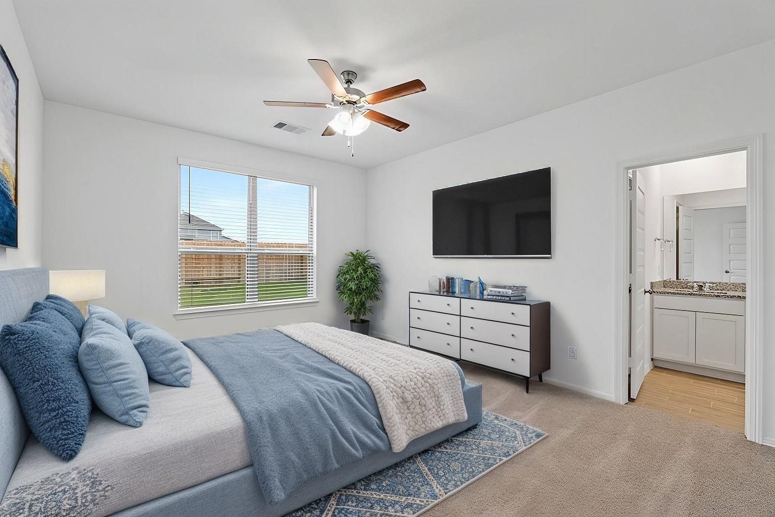 23018 Forebear Drive Katy, TX 77493 - Photo 12 of 25 a spacious bedroom with a bed and a flat screen tv