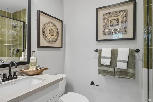 a bathroom with a toilet sink and mirror