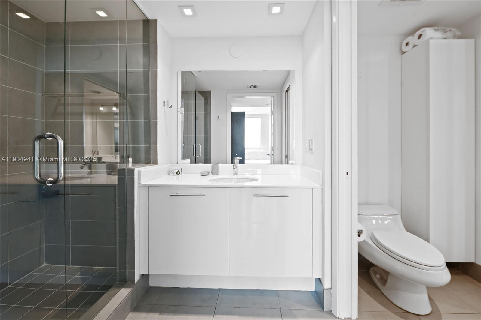 92 Southwest 3rd Street, Unit 3809 Miami, FL 33130 - Photo 17 of 32 a bathroom with a toilet sink and shower