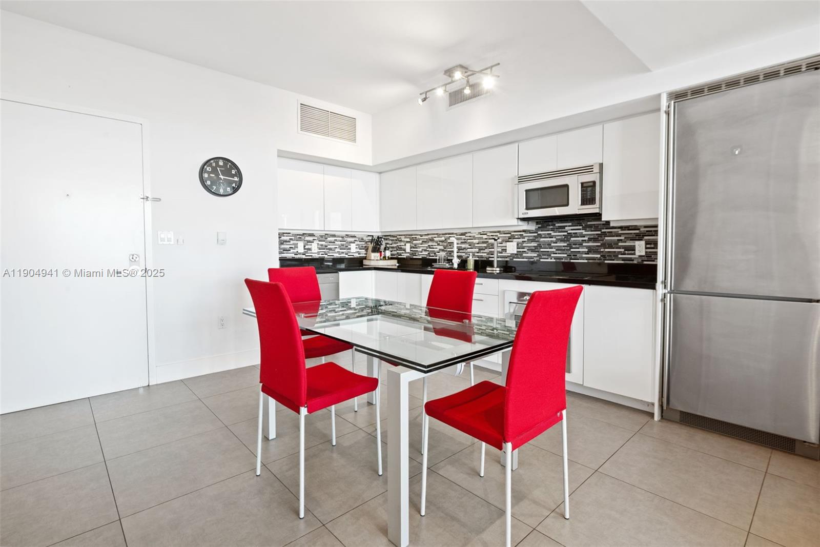 92 Southwest 3rd Street, Unit 3809 Miami, FL 33130 - Photo 5 of 32 a view of kitchen with stainless steel appliances kitchen island dining table and chairs
