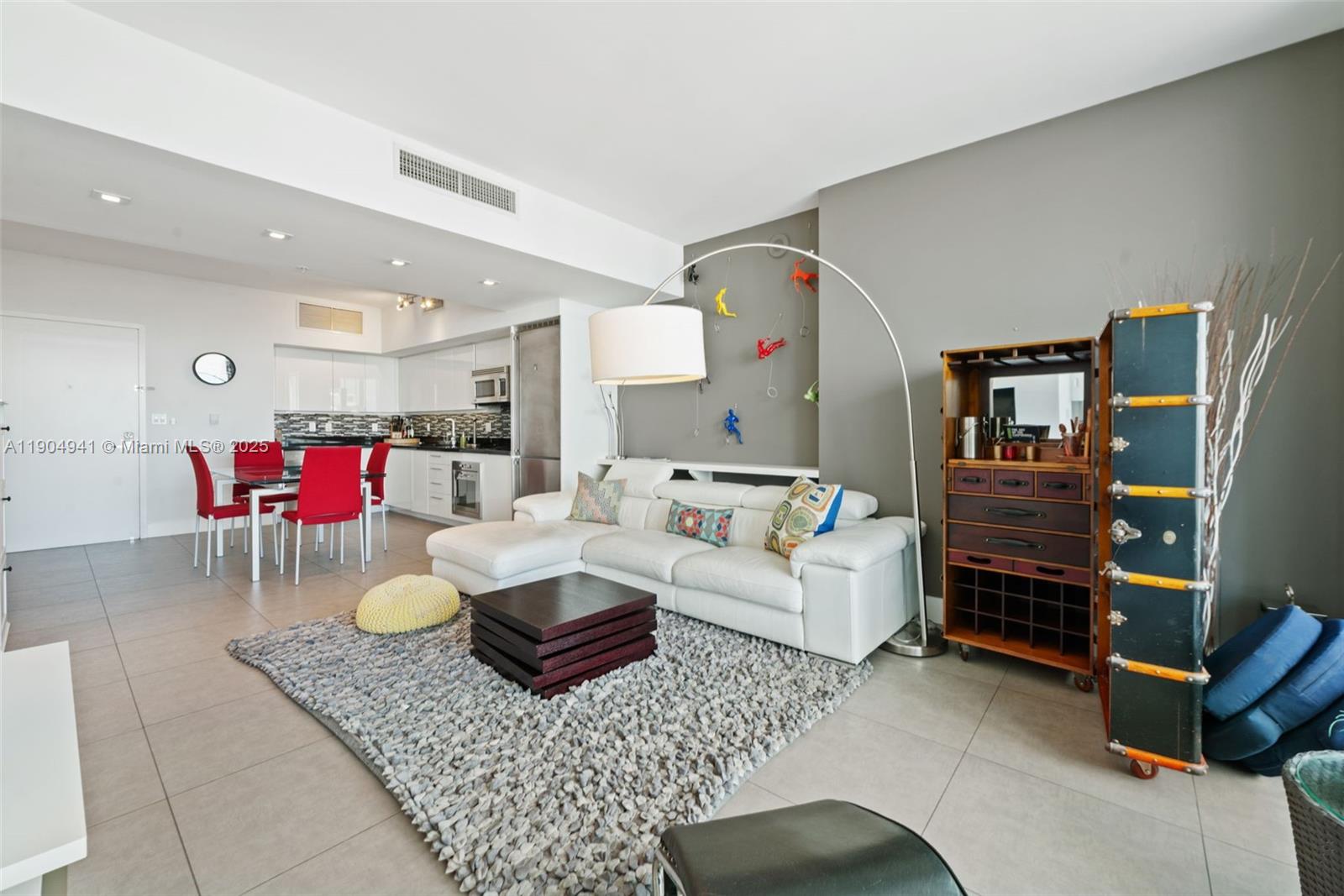 92 Southwest 3rd Street, Unit 3809 Miami, FL 33130 - Photo 7 of 32 a living room with furniture and kitchen view