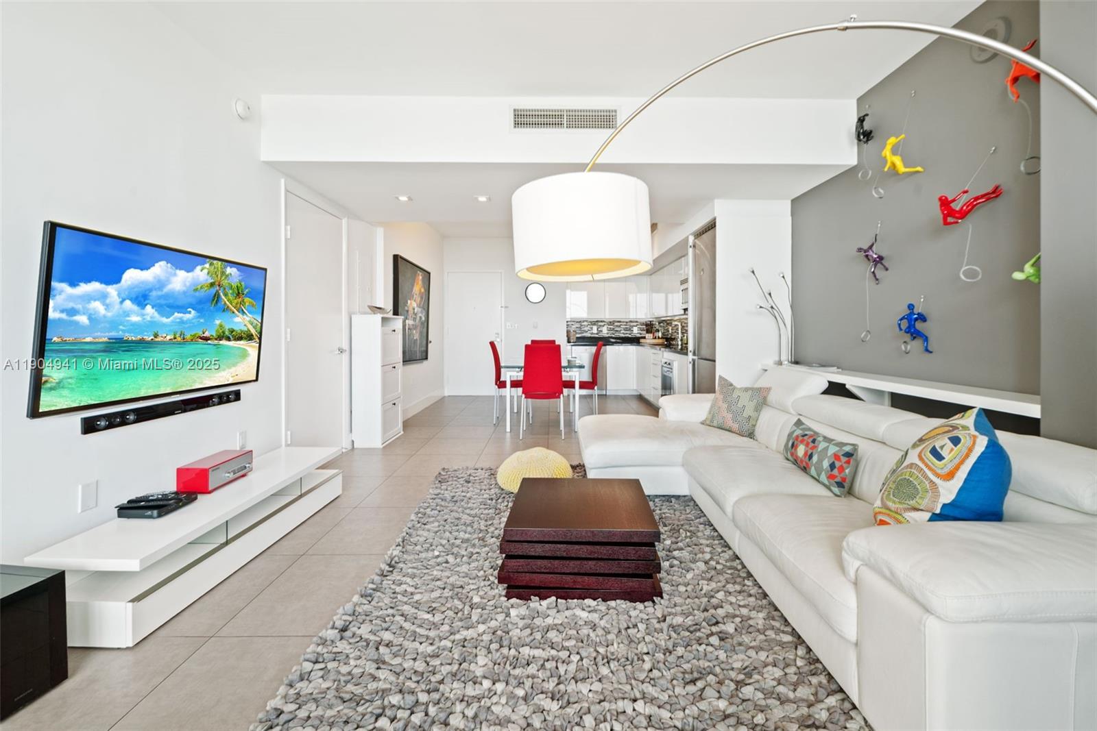 92 Southwest 3rd Street, Unit 3809 Miami, FL 33130 - Photo 8 of 32 a living room with furniture and a flat screen tv