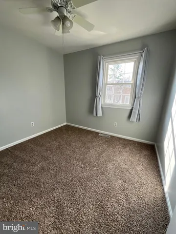 an empty room with a empty space and windows