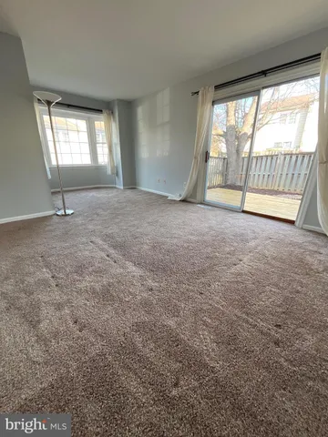 an empty room with windows and city view