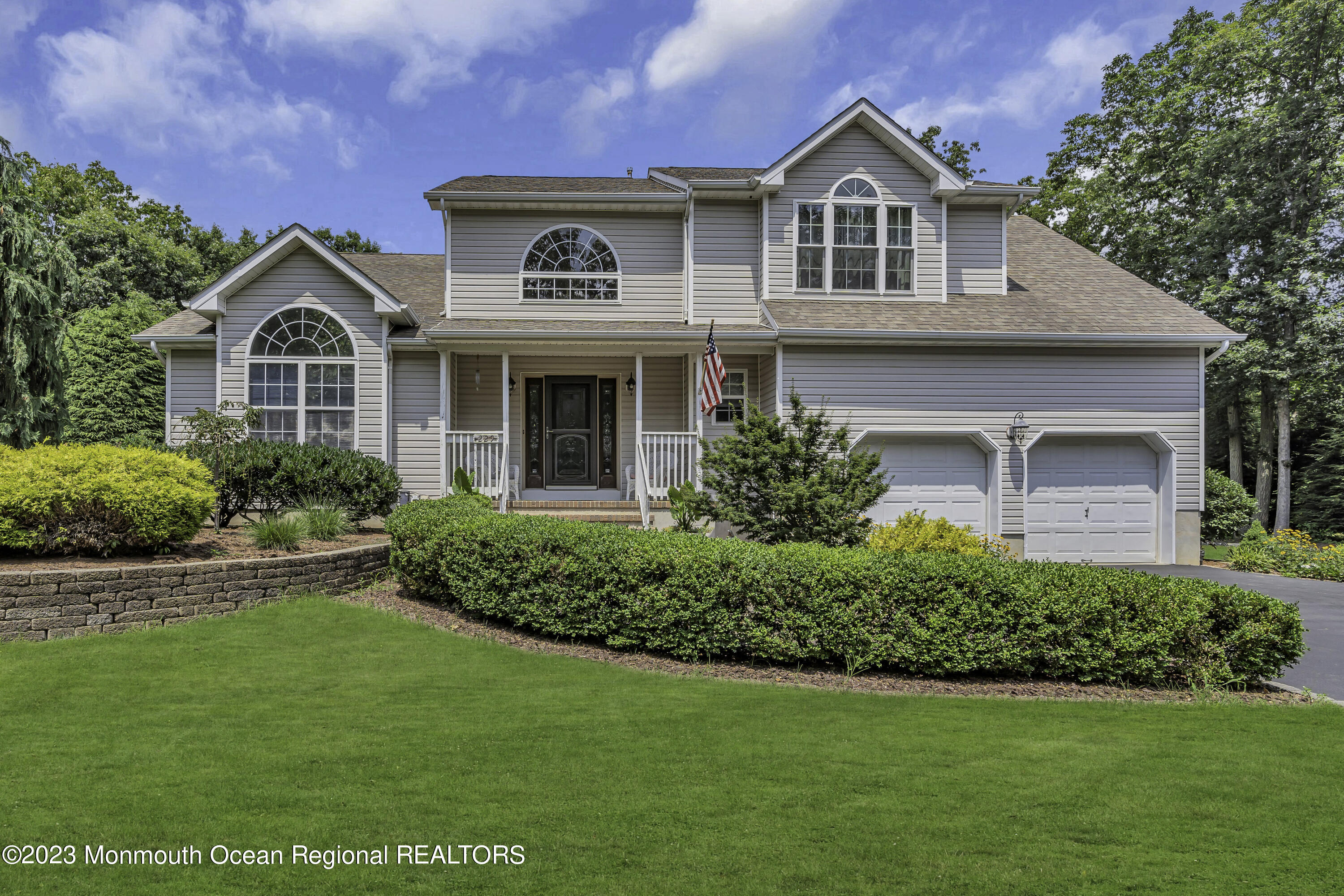 229 Lanes Mill Road Howell, NJ 07731 - Photo 1 of 58 a front view of a house with a yard and garage