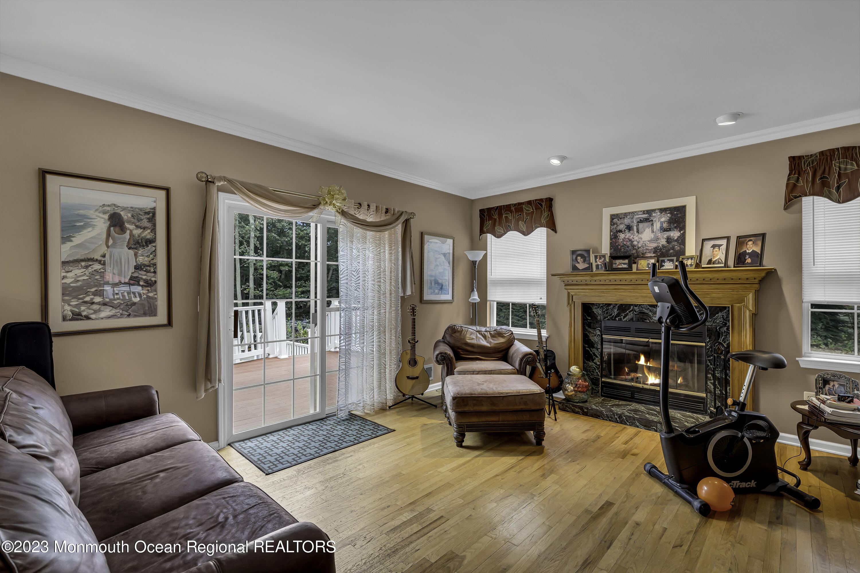 229 Lanes Mill Road Howell, NJ 07731 - Photo 15 of 58 a living room with furniture a fireplace and a flat screen tv