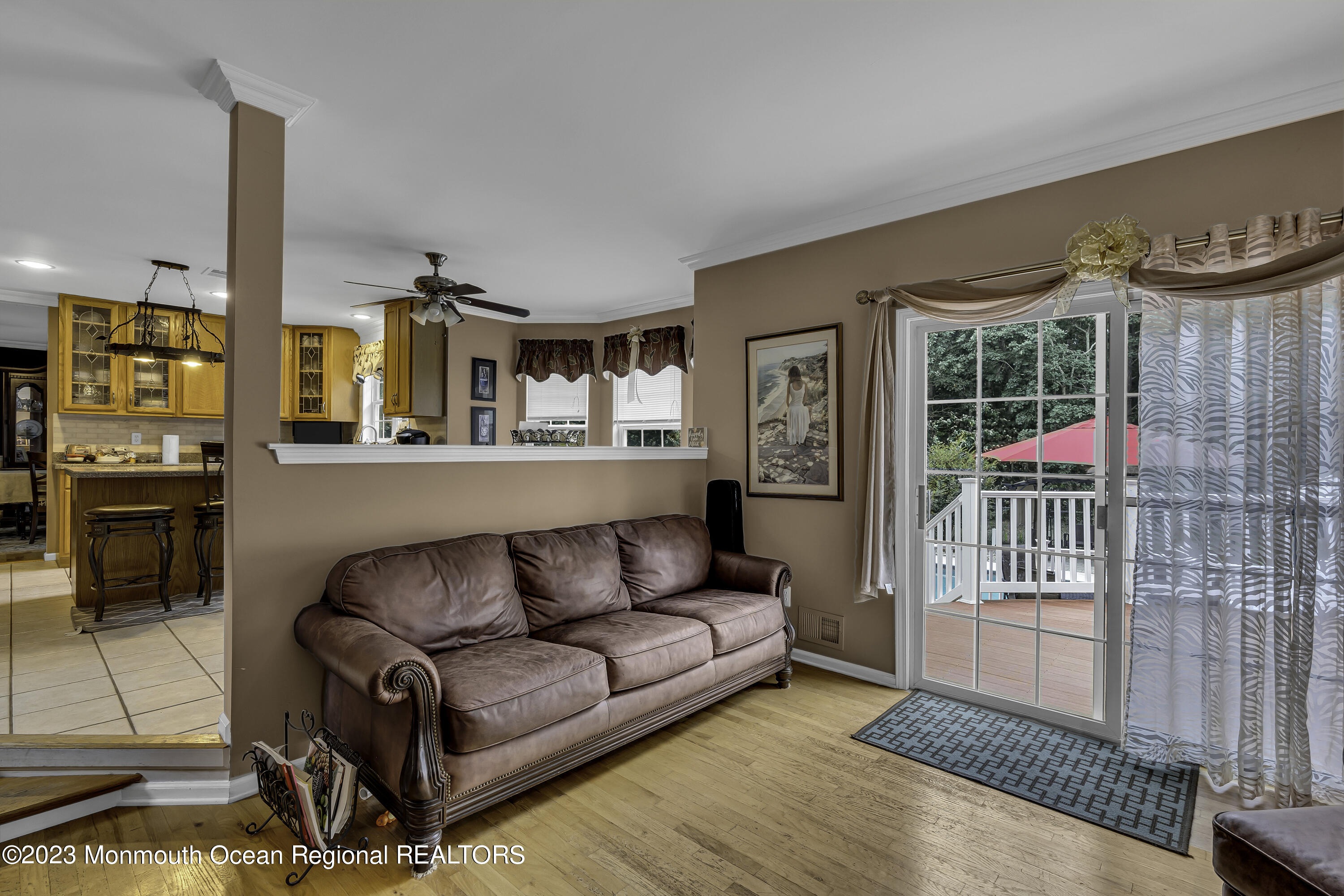 229 Lanes Mill Road Howell, NJ 07731 - Photo 17 of 58 a living room with furniture a flat screen tv and a wooden floor