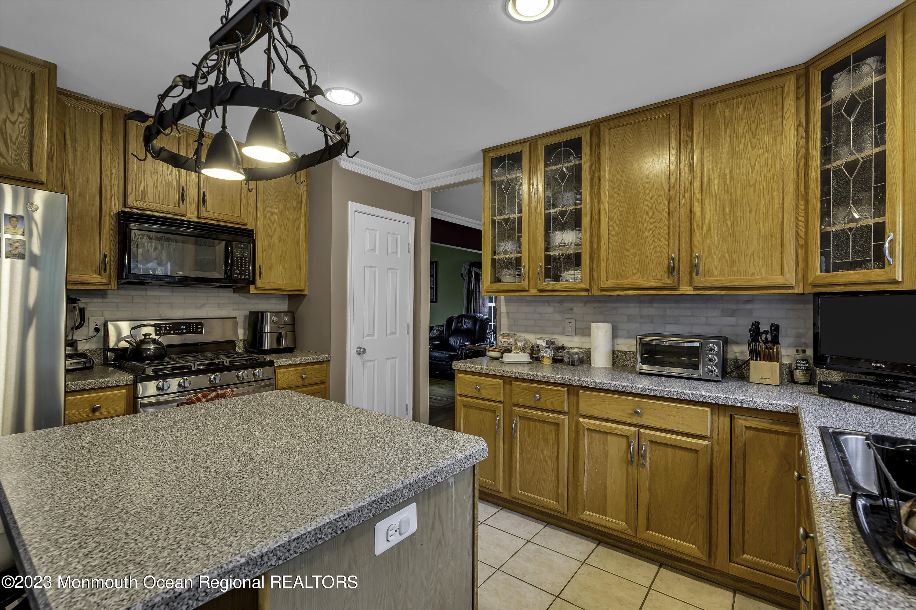 229 Lanes Mill Road Howell, NJ 07731 - Photo 18 of 58 a kitchen with stainless steel appliances granite countertop a sink dishwasher stove top oven and cabinets