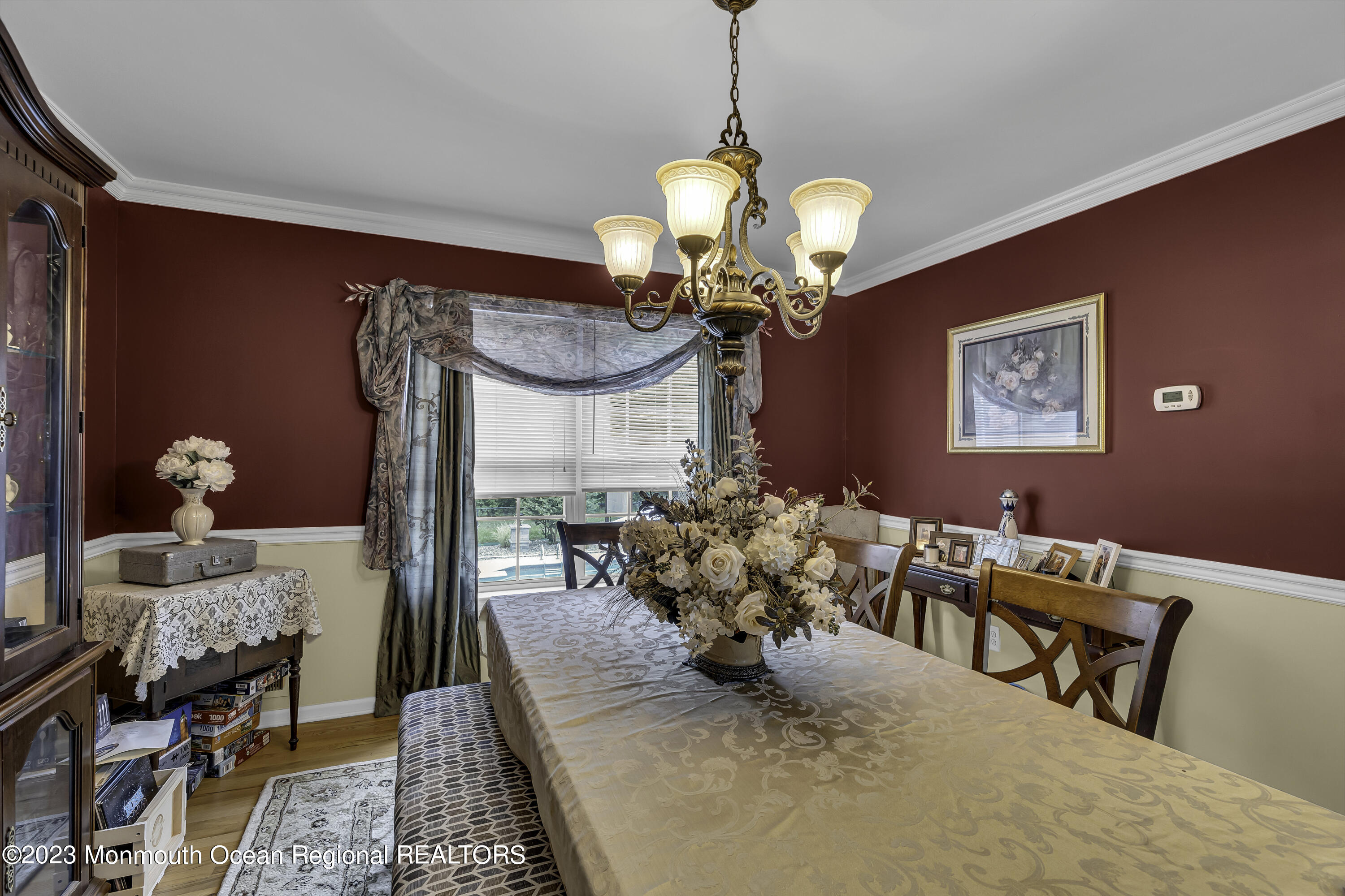 229 Lanes Mill Road Howell, NJ 07731 - Photo 20 of 58 a dining room with furniture and a chandelier