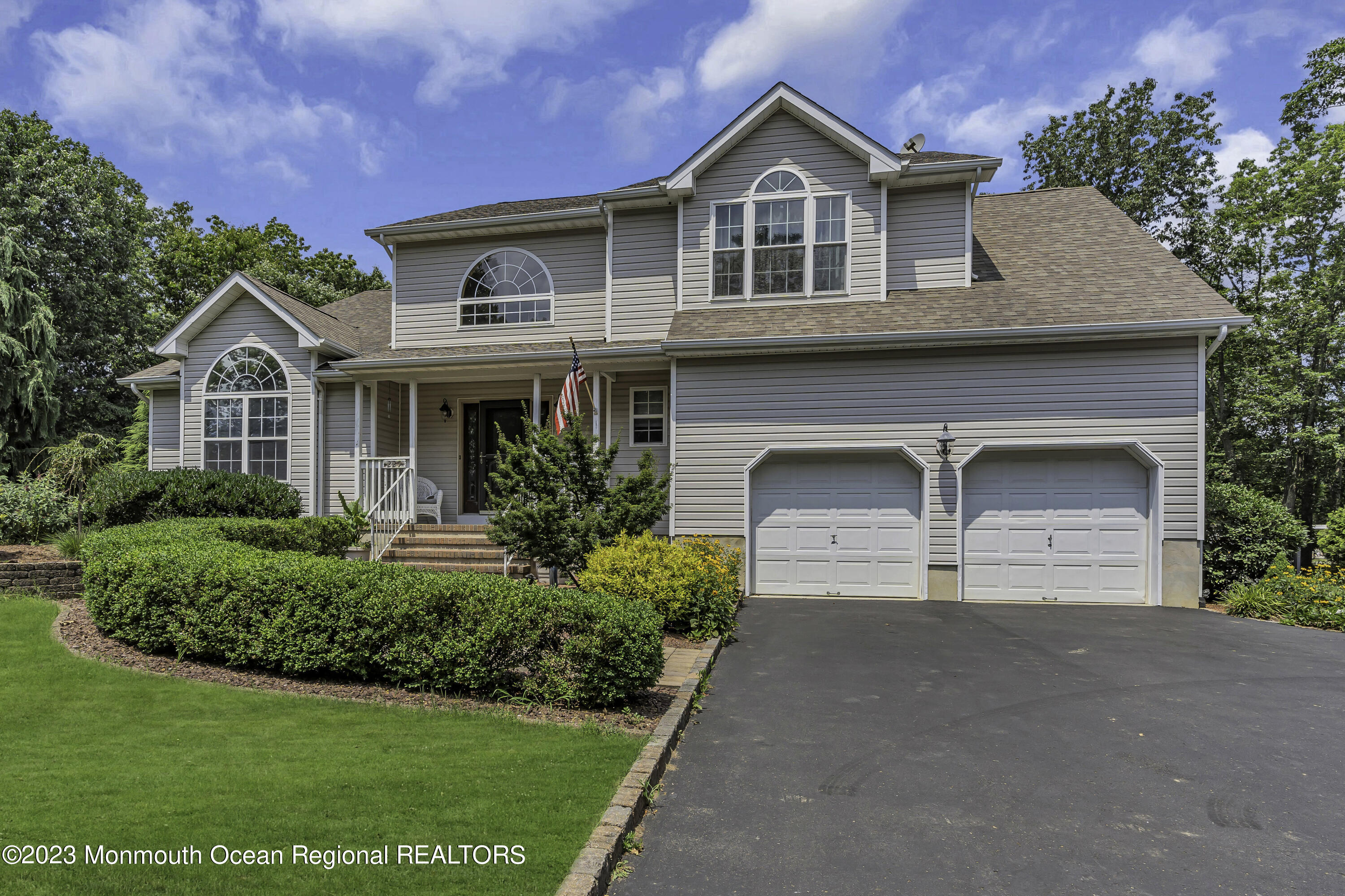 229 Lanes Mill Road Howell, NJ 07731 - Photo 2 of 58 a front view of a house with a yard and garage