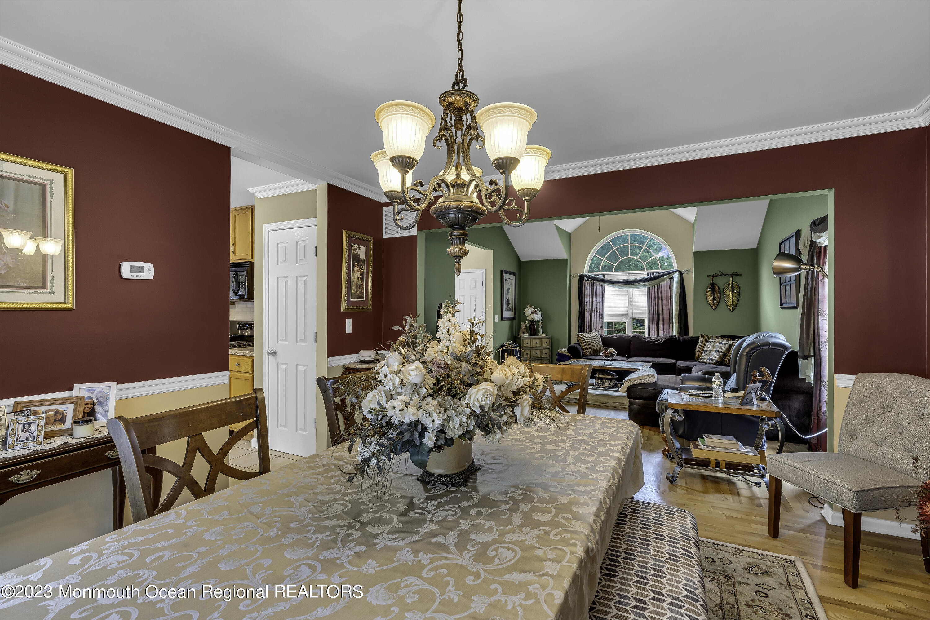 229 Lanes Mill Road Howell, NJ 07731 - Photo 21 of 58 a living room with dining table furniture and a chandelier