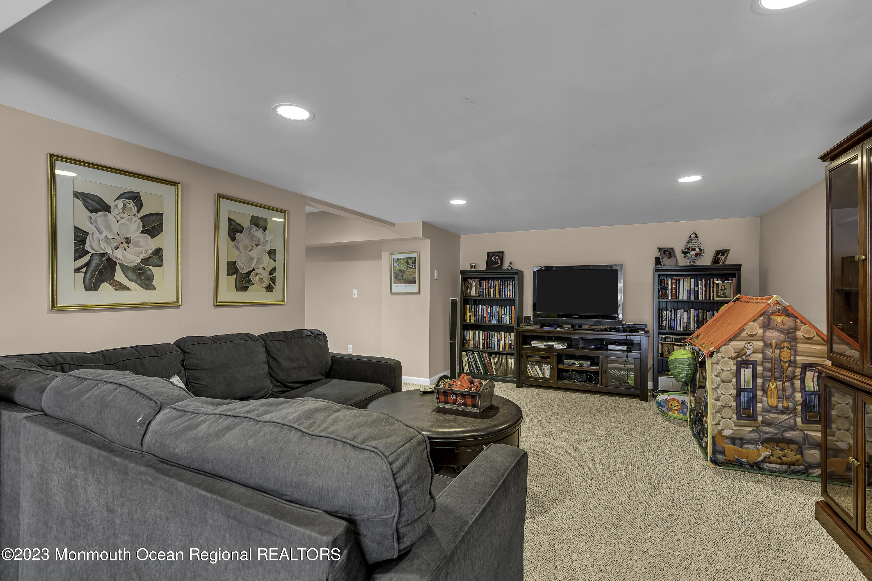 229 Lanes Mill Road Howell, NJ 07731 - Photo 30 of 58 a living room with furniture and a flat screen tv