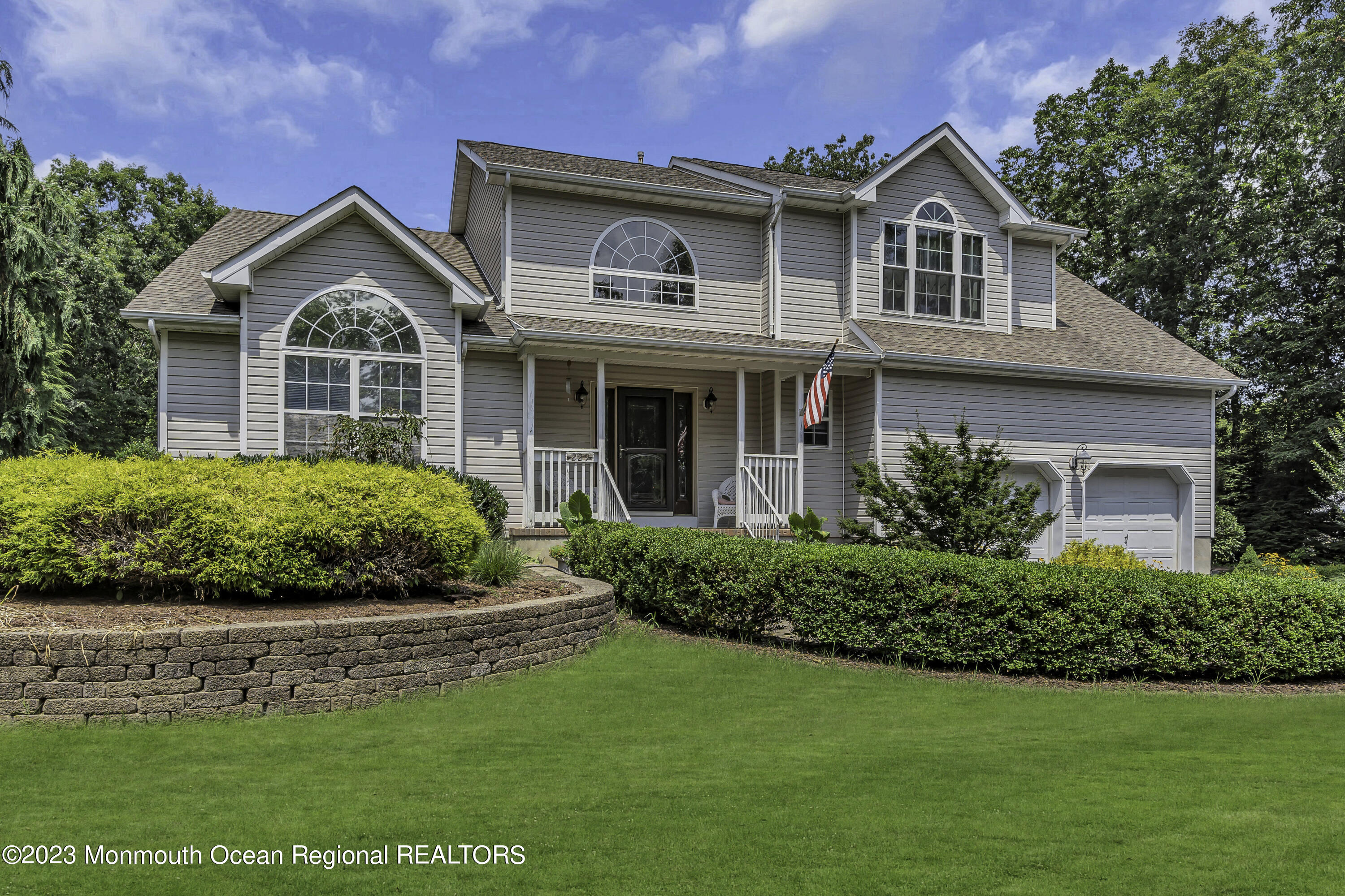 229 Lanes Mill Road Howell, NJ 07731 - Photo 3 of 58 a front view of a house with a garden