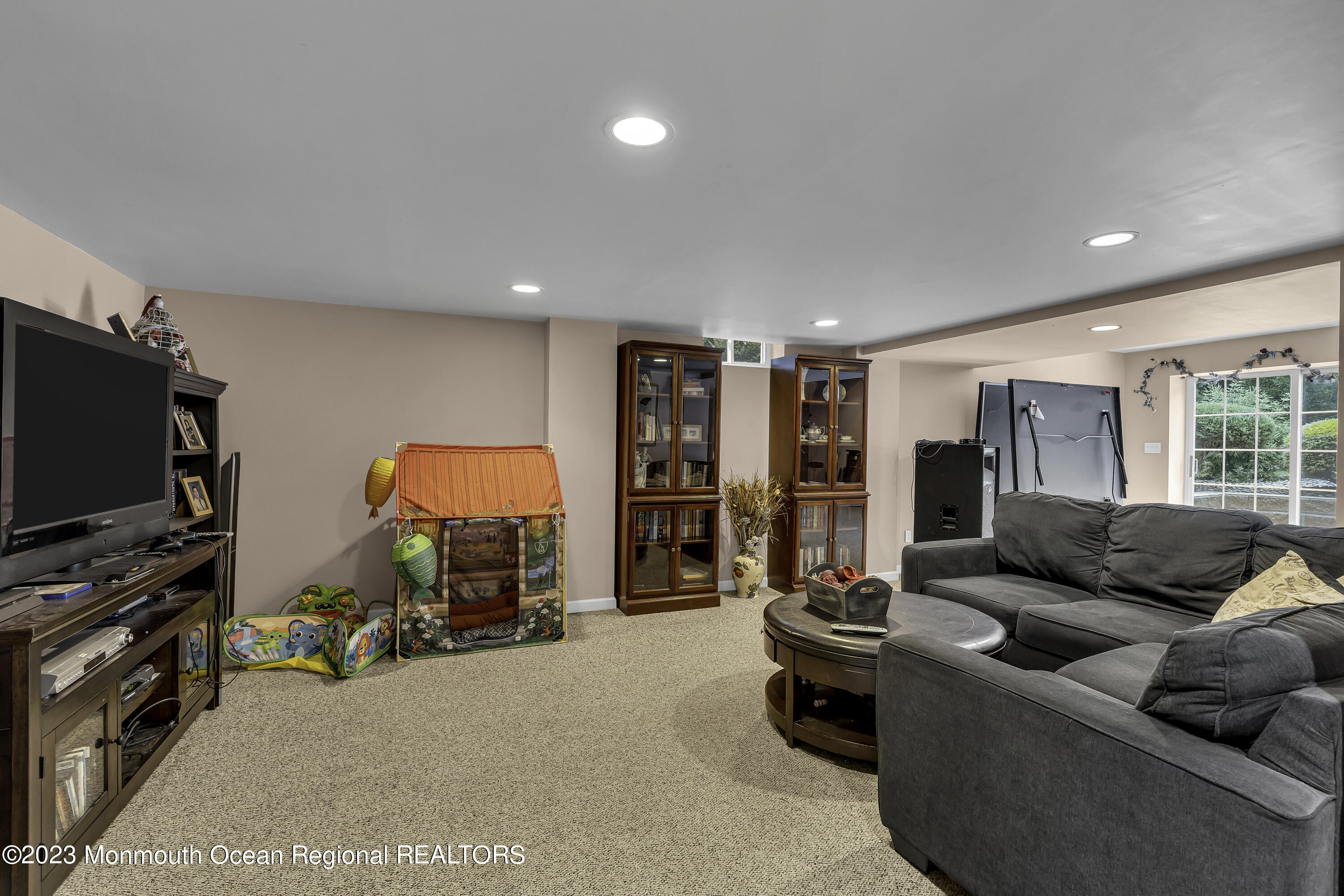 229 Lanes Mill Road Howell, NJ 07731 - Photo 31 of 58 a living room with furniture and a flat screen tv
