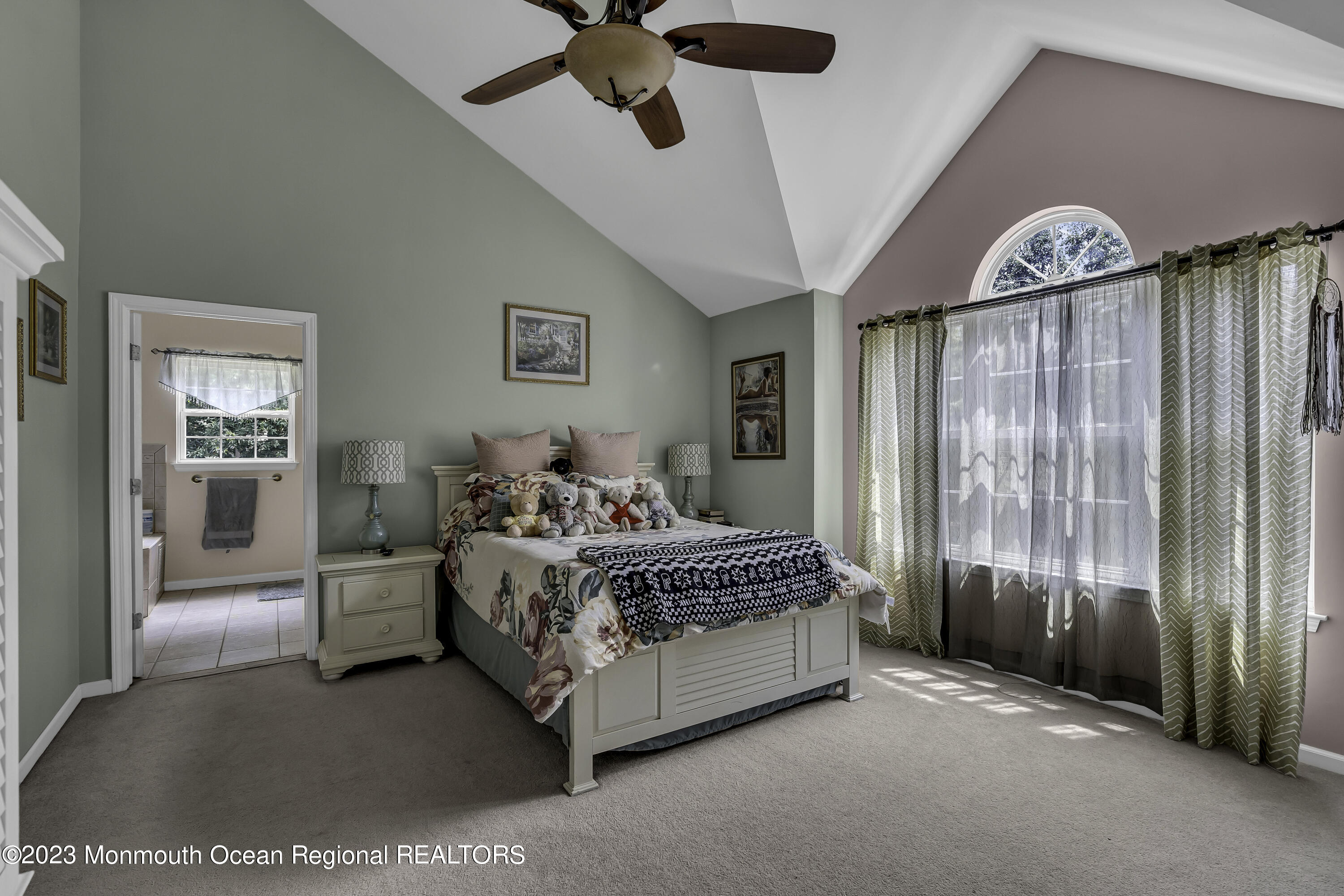 229 Lanes Mill Road Howell, NJ 07731 - Photo 34 of 58 a spacious bedroom with a bed and a chandelier