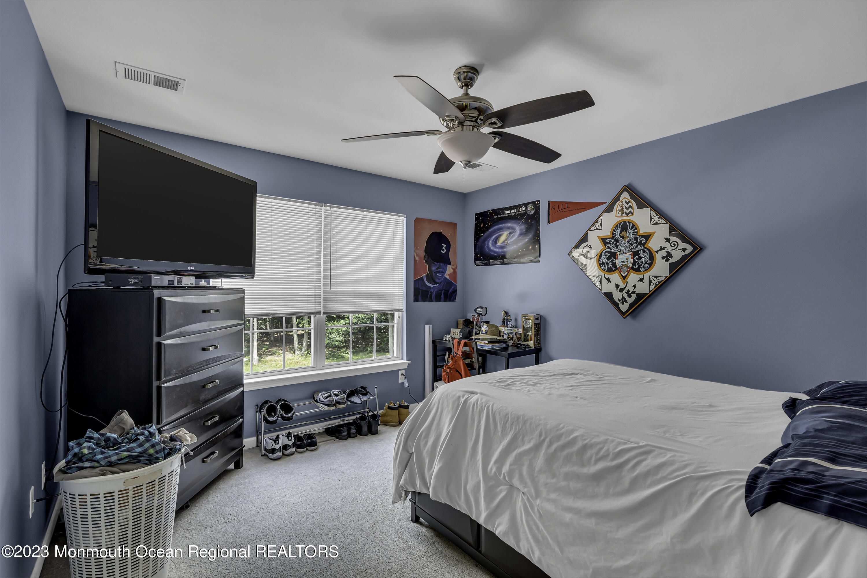 229 Lanes Mill Road Howell, NJ 07731 - Photo 39 of 58 a bed room with a bed a television and a window