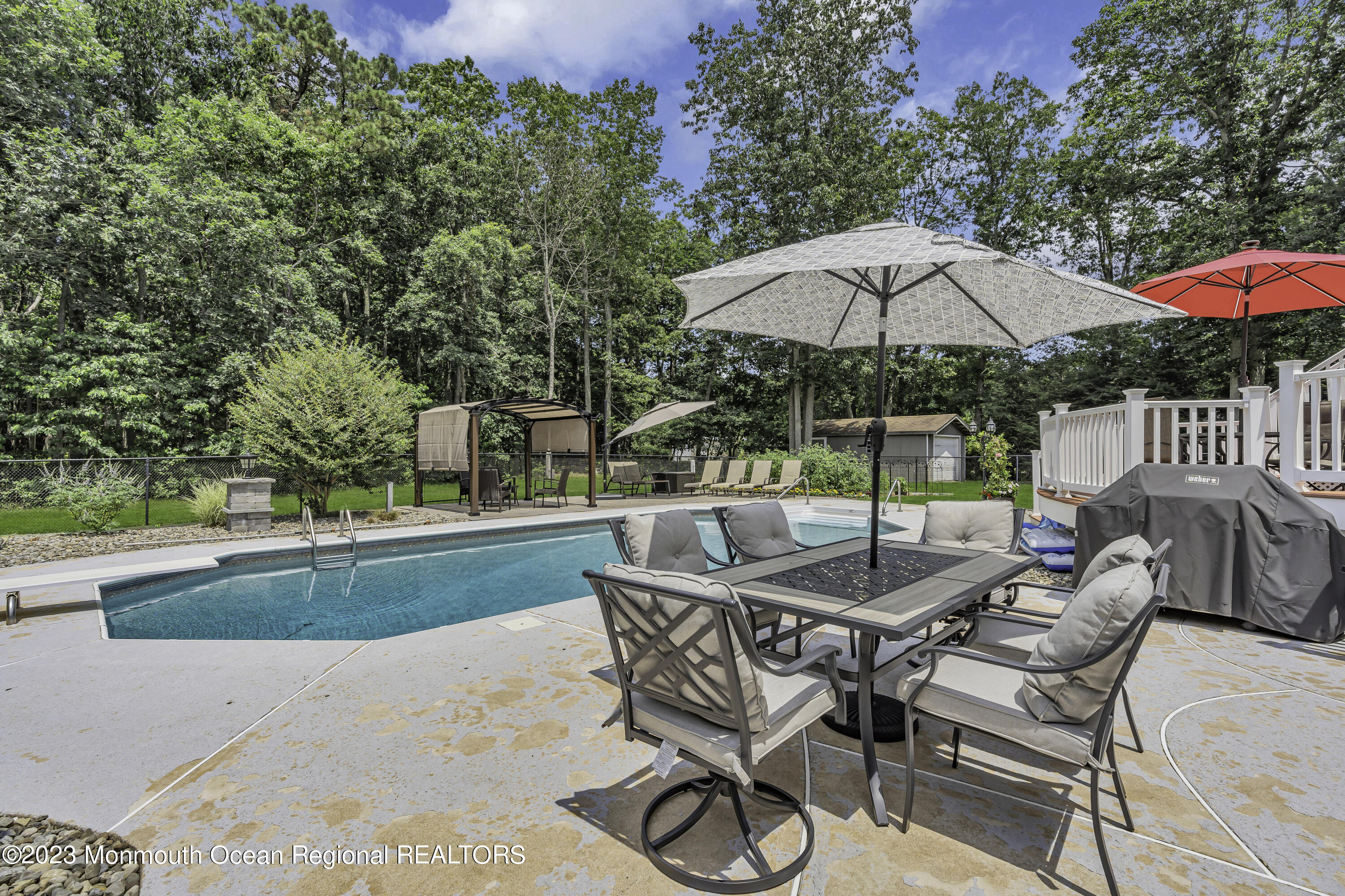 229 Lanes Mill Road Howell, NJ 07731 - Photo 42 of 58 an outdoor space with patio and white umbrellas