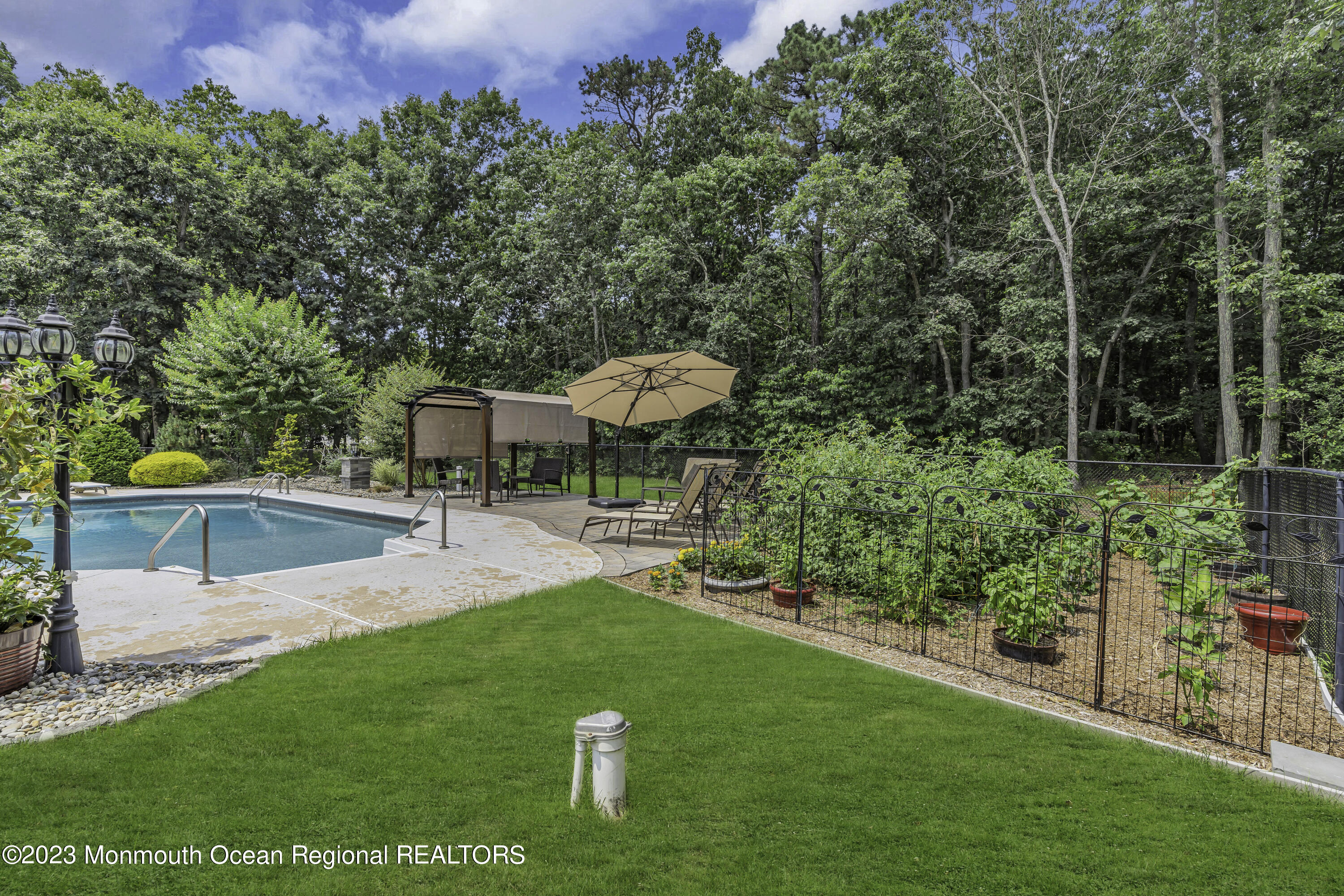 229 Lanes Mill Road Howell, NJ 07731 - Photo 46 of 58 a view of a chair and table of the garden