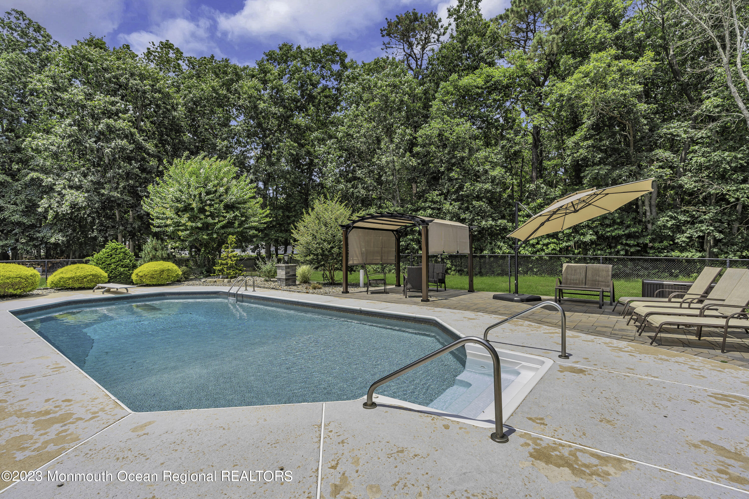 229 Lanes Mill Road Howell, NJ 07731 - Photo 48 of 58 a view of a swimming pool with a lounge chairs