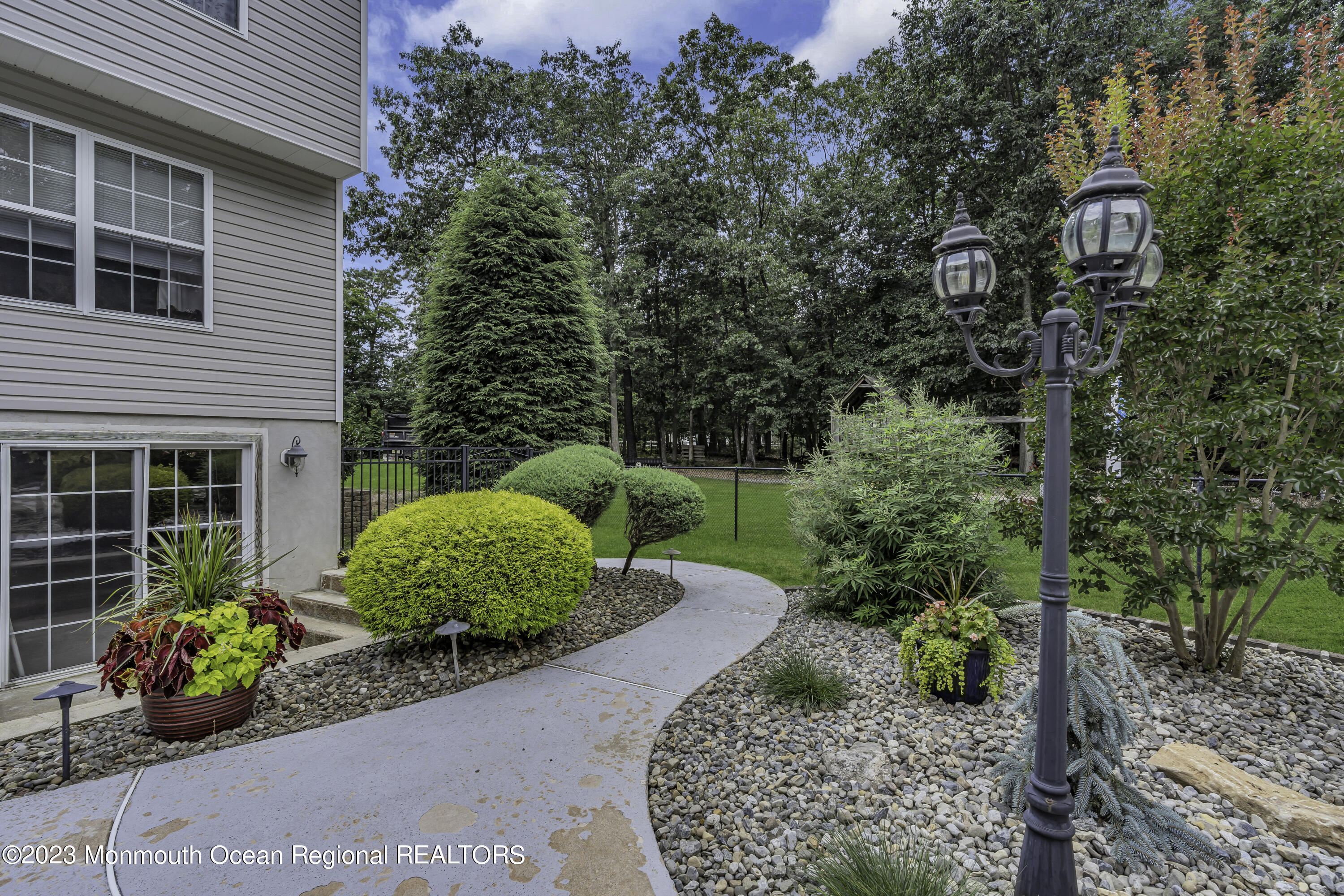 229 Lanes Mill Road Howell, NJ 07731 - Photo 52 of 58 a view of a garden with a chairs and table in a patio