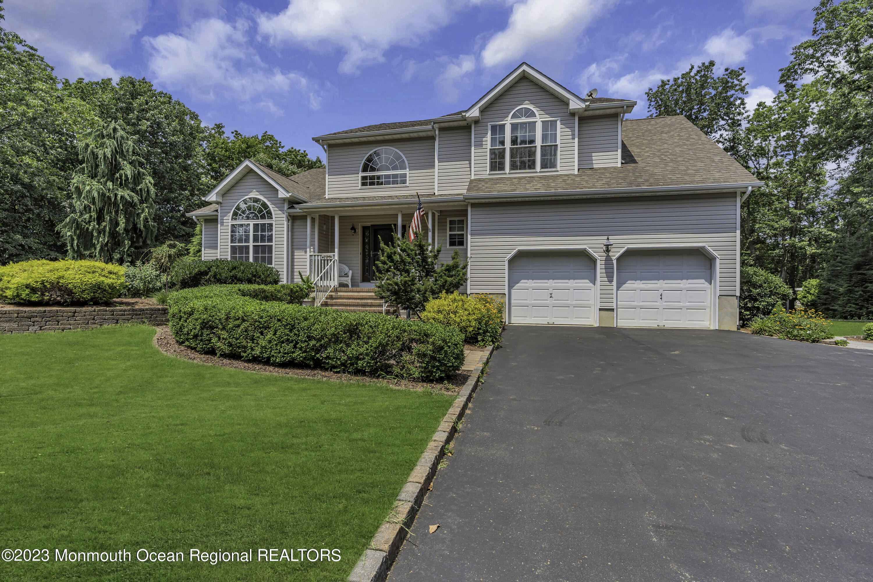 229 Lanes Mill Road Howell, NJ 07731 - Photo 6 of 58 a front view of a house with a yard and garage