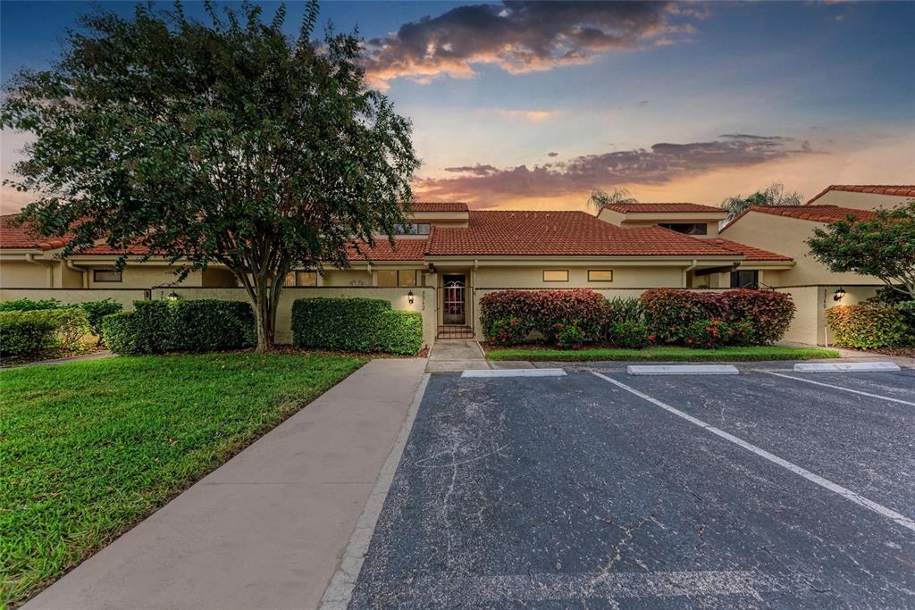 5362 Huntingwood Court, Unit 16 Sarasota, FL 34235 - Photo 1 of 46 front view of a house with a yard