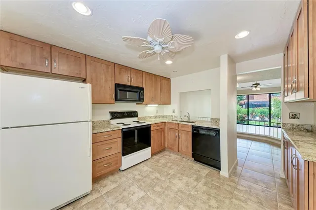 a kitchen with stainless steel appliances granite countertop a refrigerator stove a sink and dishwasher
