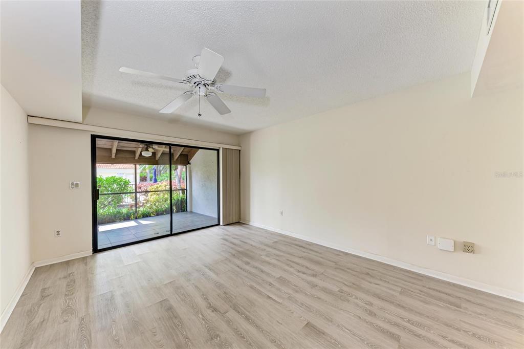 5362 Huntingwood Court, Unit 16 Sarasota, FL 34235 - Photo 20 of 46 wooden floor in an empty room with a window