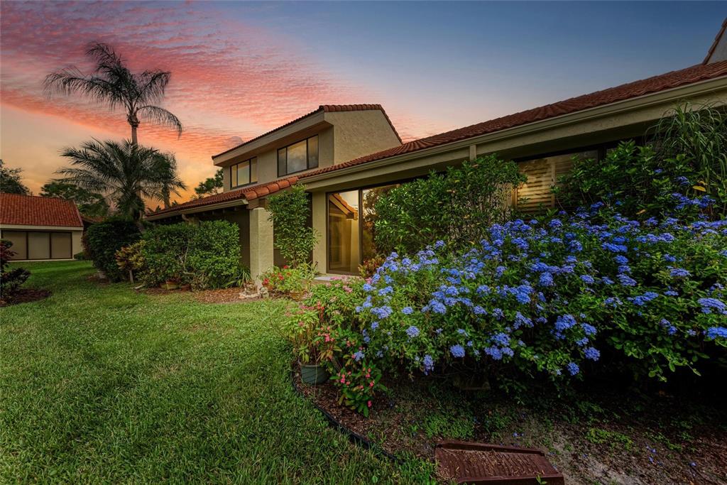 5362 Huntingwood Court, Unit 16 Sarasota, FL 34235 - Photo 2 of 46 a backyard of a house with lots of green space