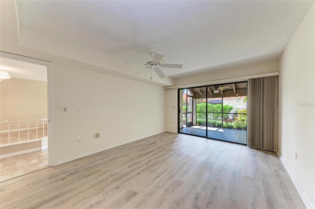 5362 Huntingwood Court, Unit 16 Sarasota, FL 34235 - Photo 23 of 46 wooden floor in an empty room with a window