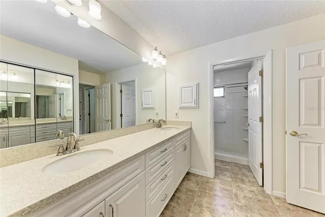 a spacious bathroom with a double vanity sink mirror and double