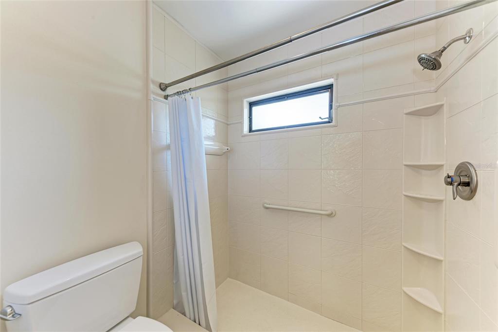 5362 Huntingwood Court, Unit 16 Sarasota, FL 34235 - Photo 26 of 46 a bathroom with a toilet and a shower