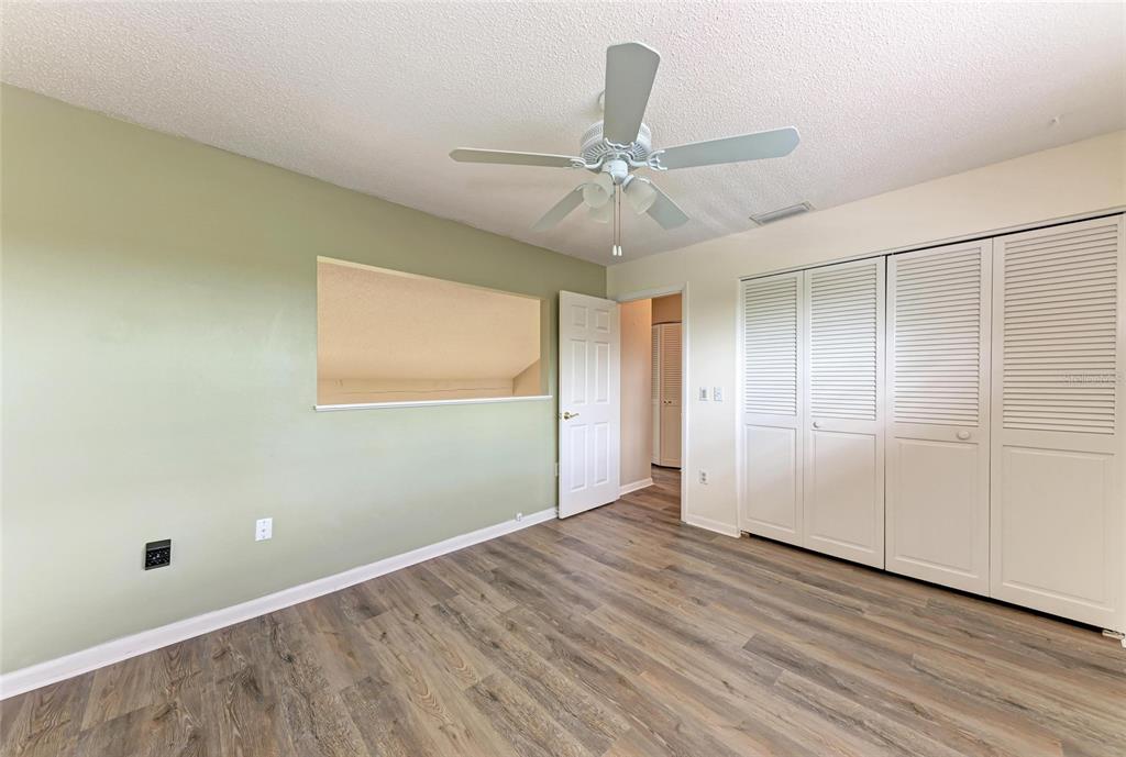 5362 Huntingwood Court, Unit 16 Sarasota, FL 34235 - Photo 29 of 46 a view of an empty room with wooden floor