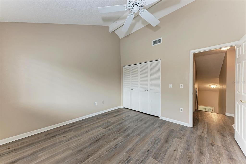 5362 Huntingwood Court, Unit 16 Sarasota, FL 34235 - Photo 31 of 46 a view of an empty room with wooden floor