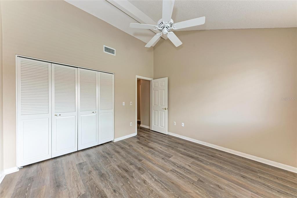 5362 Huntingwood Court, Unit 16 Sarasota, FL 34235 - Photo 32 of 46 a view of an empty room with wooden floor