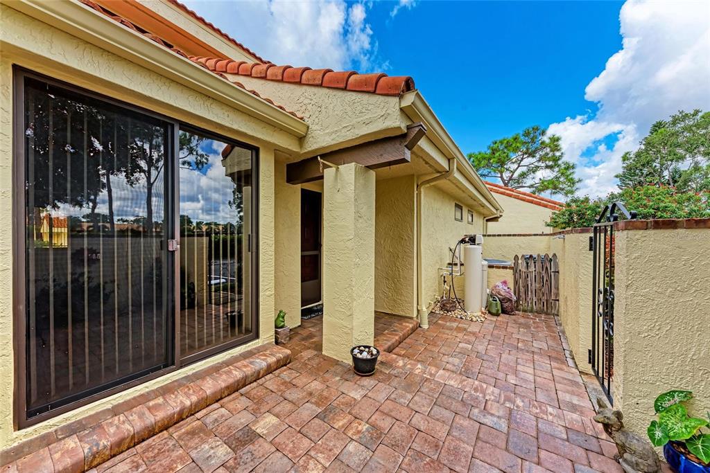 5362 Huntingwood Court, Unit 16 Sarasota, FL 34235 - Photo 4 of 46 a view of a house with wooden floor and a potted plant