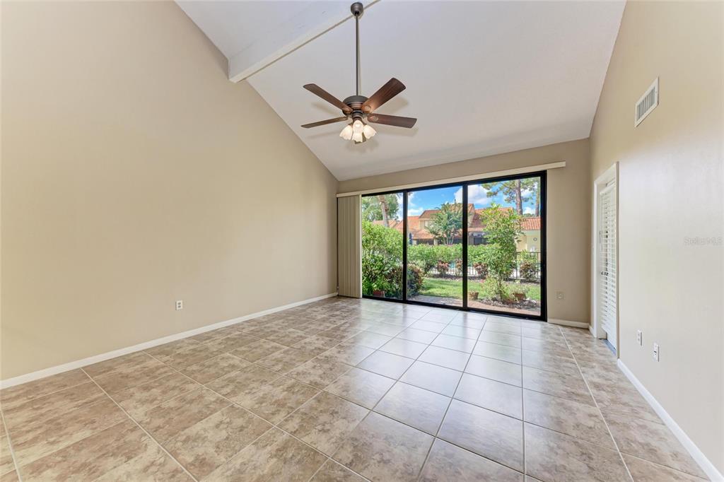 5362 Huntingwood Court, Unit 16 Sarasota, FL 34235 - Photo 9 of 46 a view of a livingroom with a ceiling fan and window